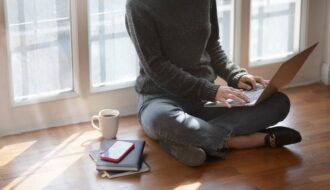 woman in gray sweat shirt sitting beside window